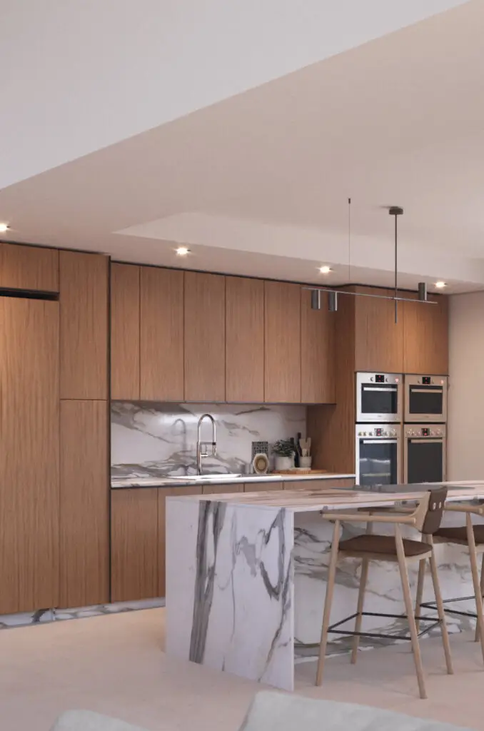 Encuadre de detalle en cocina moderna mostrando el encuentro entre la encimera de mármol y la carpintería de madera.
